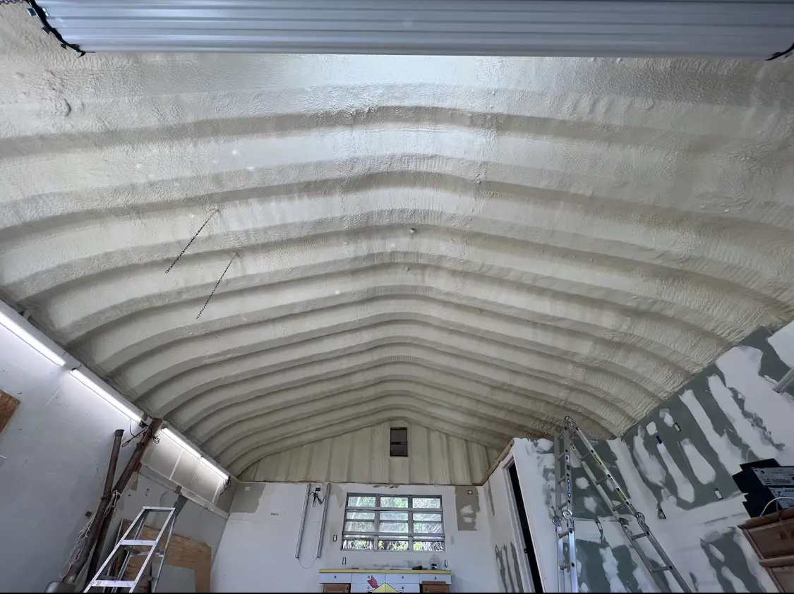 Spray polyurethane foam applied to the underside of a metal roof deck in Hermiston